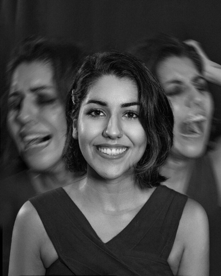 A portrait capturing the contrast of a smiling woman with expressions of despair in black and white.