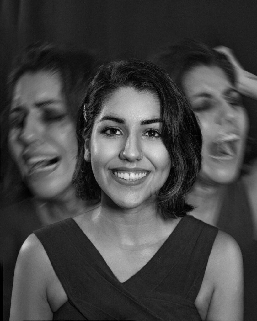 A portrait capturing the contrast of a smiling woman with expressions of despair in black and white.